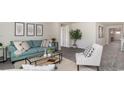 Cozy living room with comfortable seating, neutral decor and a view into the entry way at 201 Ashworth Dr., Tabor City, NC 28463