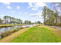 Scenic view of the golf course and pond, surrounded by lush greenery and the condo community at 242 Sun Colony Blvd. # 303, Longs, SC 29568