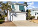 Two-story home with white garage door and teal shutters at 301 Splendor Circle, Murrells Inlet, SC 29576