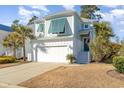 Charming two-story home with a white garage door and teal shutters at 301 Splendor Circle, Murrells Inlet, SC 29576