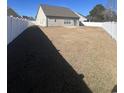 Spacious, fenced backyard with a well-maintained lawn, offering ample space for outdoor activities at 389 Cabo Loop, Myrtle Beach, SC 29588
