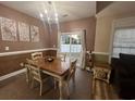 Comfortable dining room with a chandelier, decorative art, and sliding door access to the backyard at 389 Cabo Loop, Myrtle Beach, SC 29588