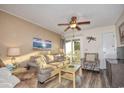 Living room with sofa, chair, and ocean-themed decor at 401 N Hillside Dr. # 3C, North Myrtle Beach, SC 29582