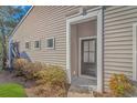 Home exterior featuring a modern black front door and landscaping at 4348 Livorn Loop # 4348, Myrtle Beach, SC 29579