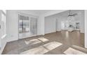 Sunlit living room with tile floors and sliding doors to patio at 500 Cordgrass Ln., Little River, SC 29566