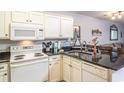 White kitchen cabinets, granite counters, and appliances at 562 Blue Stem Dr. # 54D, Pawleys Island, SC 29585