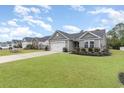 Beautiful one-story home boasts a lush green lawn in a well-maintained neighborhood at 688 Tattlesbury Dr., Conway, SC 29526
