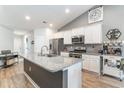 Modern kitchen featuring granite countertops, white cabinets, and stainless steel appliances at 688 Tattlesbury Dr., Conway, SC 29526