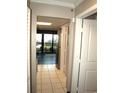 A hallway with tile floors, leading to the kitchen and bedrooms at 6900 N Ocean Blvd. # 111, Myrtle Beach, SC 29572