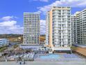 Aerial view of oceanfront high-rise building with pool and beach access at 9550 Shore Dr. # 432, Myrtle Beach, SC 29572