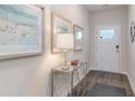 Bright and airy entryway with a console table, lamp, and framed artwork at 1134 Black Lake Way, Conway, SC 29526