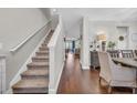 Staircase with carpet runner and hardwood floors in the hallway at 1208 Maxwell Dr., Little River, SC 29566