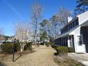 Landscaped grounds with gray houses and walkway at 1210 Benna Dr. # B, Myrtle Beach, SC 29577