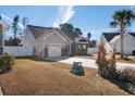 Exterior view of a well-maintained single-Gathering home with attached garage, paved driveway, and fenced yard at 160 Maggie Way, Myrtle Beach, SC 29588