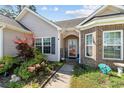 A welcoming front entrance with colorful landscaping and inviting decor at 160 Maggie Way, Myrtle Beach, SC 29588