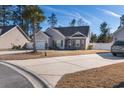 Well-maintained single-Gathering home with a landscaped front yard and a paved driveway leading to an attached garage at 160 Maggie Way, Myrtle Beach, SC 29588