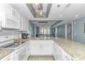 Modern kitchen with granite countertops and white cabinets at 161 Seawatch Dr. # 1017, Myrtle Beach, SC 29572
