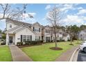 Row of townhouses with neatly landscaped yards at 173 Olde Towne Way # 3, Myrtle Beach, SC 29588