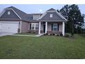 New home with gray and beige siding and a two-car garage at 204 Palmetto Sand Loop, Conway, SC 29527