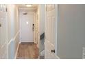 Gray hallway with wood-look flooring, doors, and stairs at 2406 N Ocean Blvd. # Ph4-1704, Myrtle Beach, SC 29577