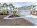 Gray house with white garage door and landscaped yard at 3040 Thoroughfare Dr., Conway, SC 29526