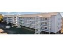 Beautiful beach condo complex, featuring balconies and staircases, in a prime location at 310 Marsh Pl. # 108, Garden City Beach, SC 29576