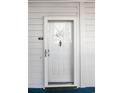 White front door with glass panel and nautical decor at 310 Marsh Pl. # 108, Garden City Beach, SC 29576