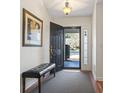 Bright entryway with hardwood floors, a bench, and an open door to backyard at 3169 Shorecrest Bay Dr., Murrells Inlet, SC 29576