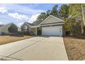 House exterior showcasing a two-car garage and well-maintained lawn at 3169 Shorecrest Bay Dr., Murrells Inlet, SC 29576