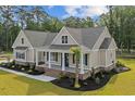 Beautifully landscaped single-Gathering home with a charming front porch, columns and a well-manicured lawn at 3220 Highway 19, Conway, SC 29526