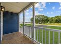 Covered porch with white railings and wood flooring at 3772 Green Sea Rd., Green Sea, SC 29545