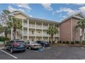 Front view of a two-story building with parking at 4271 Hibiscus Dr. # 201, Little River, SC 29566