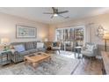 Living room with gray sofa, coffee table, and access to patio at 4271 Hibiscus Dr. # 201, Little River, SC 29566