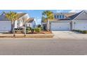Two-story home with a two-car garage and manicured landscaping at 4379 Livorn Loop # 4379, Myrtle Beach, SC 29579
