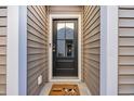 Modern black front door with a welcome mat at 4379 Livorn Loop # 4374, Myrtle Beach, SC 29579