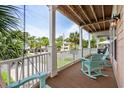 Relaxing covered balcony with rocking chairs and swing, perfect for enjoying the coastal breeze at 504 21St Ave. N, North Myrtle Beach, SC 29582