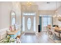 Open concept dining area featuring a light and airy feel, hardwood floors, and a charming chandelier at 520 Hobie Cat Rd., Myrtle Beach, SC 29588