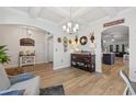 Spacious dining area with hardwood floors, elegant decor, and view to the kitchen at 528 Fanciful Way, Myrtle Beach, SC 29588