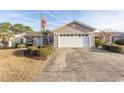 Tan house with a two car garage and American flag at 567 Woodholme Dr., Conway, SC 29526