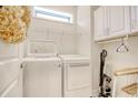 Bright laundry room with washer, dryer, and ample shelving at 6070 Tramonto St., Myrtle Beach, SC 29577