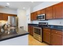 Bright kitchen featuring stainless steel appliances, dark countertops, and wood cabinetry at 900 British Ln. # 1187, Myrtle Beach, SC 29579