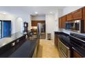 Kitchen boasting dark countertops, stainless steel appliances, and tiled floors at 900 British Ln. # 1187, Myrtle Beach, SC 29579
