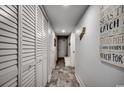 Hallway with white doors and trim, wood-look flooring, and nautical decorations on the wall at 1012 N Waccamaw Dr. # 902, Murrells Inlet, SC 29576