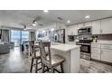 Modern kitchen with white cabinets, marble countertops, stainless steel appliances, and adjacent dining area at 1012 N Waccamaw Dr. # 902, Murrells Inlet, SC 29576