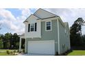 Two-story house with gray siding, white accents, and a two-car garage at 1106 Black Lake Way, Conway, SC 29526