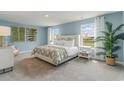 Spacious bedroom with light blue walls and a comfortable bed at 1122 Black Lake Way, Conway, SC 29526