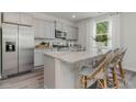 Modern kitchen with gray cabinets, granite island, and stainless steel appliances at 1122 Black Lake Way, Conway, SC 29526