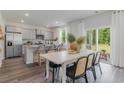 Bright kitchen features a breakfast bar, dining area, and sliding glass doors to backyard at 1122 Black Lake Way, Conway, SC 29526