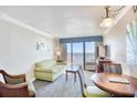 Living room boasts ocean views, comfy seating, and a dining area at 1200 N Ocean Blvd. # 910, Myrtle Beach, SC 29577