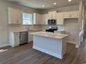 Modern kitchen featuring stainless steel appliances, white cabinets, and an island at 1312 Winding Creek Way, Myrtle Beach, SC 29588